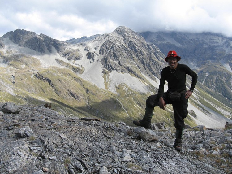 Photo of explorer and Author J. Robert Harris standing in mountain landscape